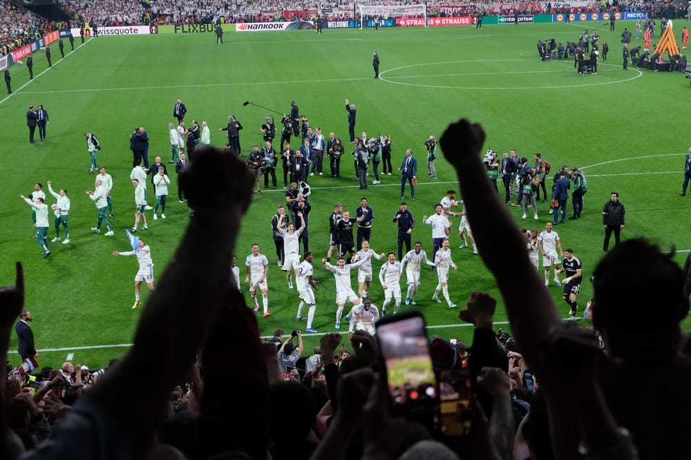 Aston Villa players celebrate their Europa League win in front of the fans