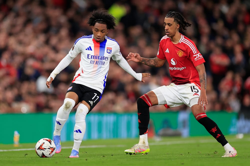 Malick Fofana (11) of Olympique Lyonnais is challenged by Leny Yoro (15) of Manchester United during the Europa League quarter final second leg match between Manchester United and Olympique Lyonnais at Old Trafford, Manchester, England on 17 April 2025.