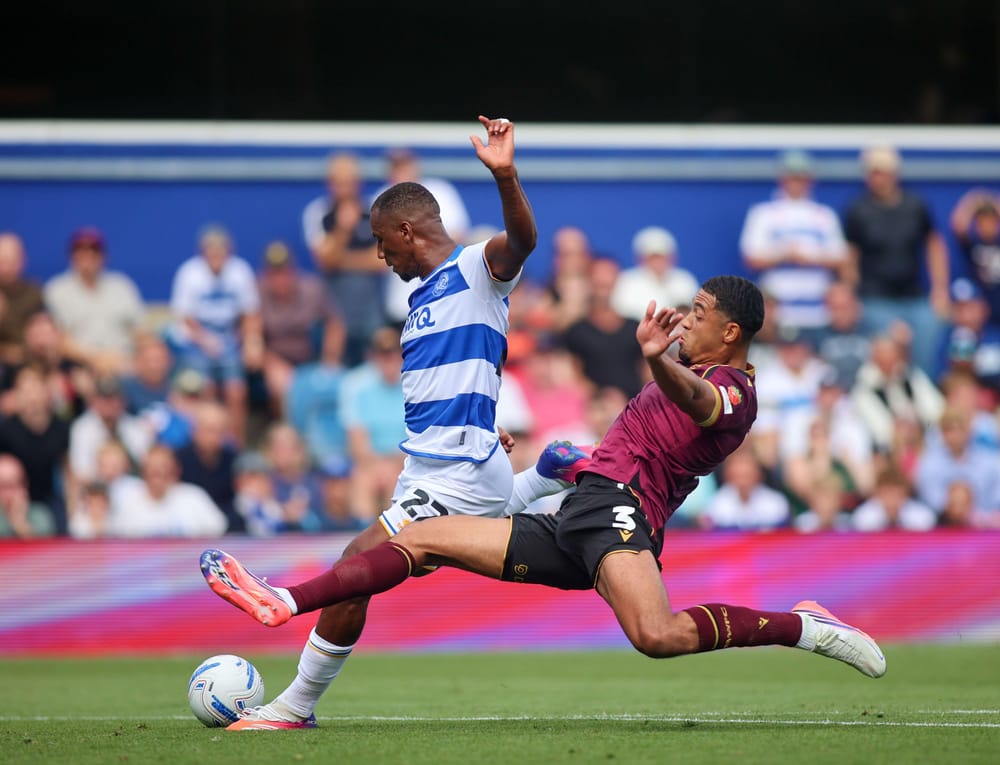 3FB43WY Queens Park Rangers's Richard Kone (left) battles for the ball with Bolton Wanderers' Chris Forino during the Sky Bet Championship match at MATRADE Loftus Road Stadium, London. Picture date: Saturday August 22, 2026.